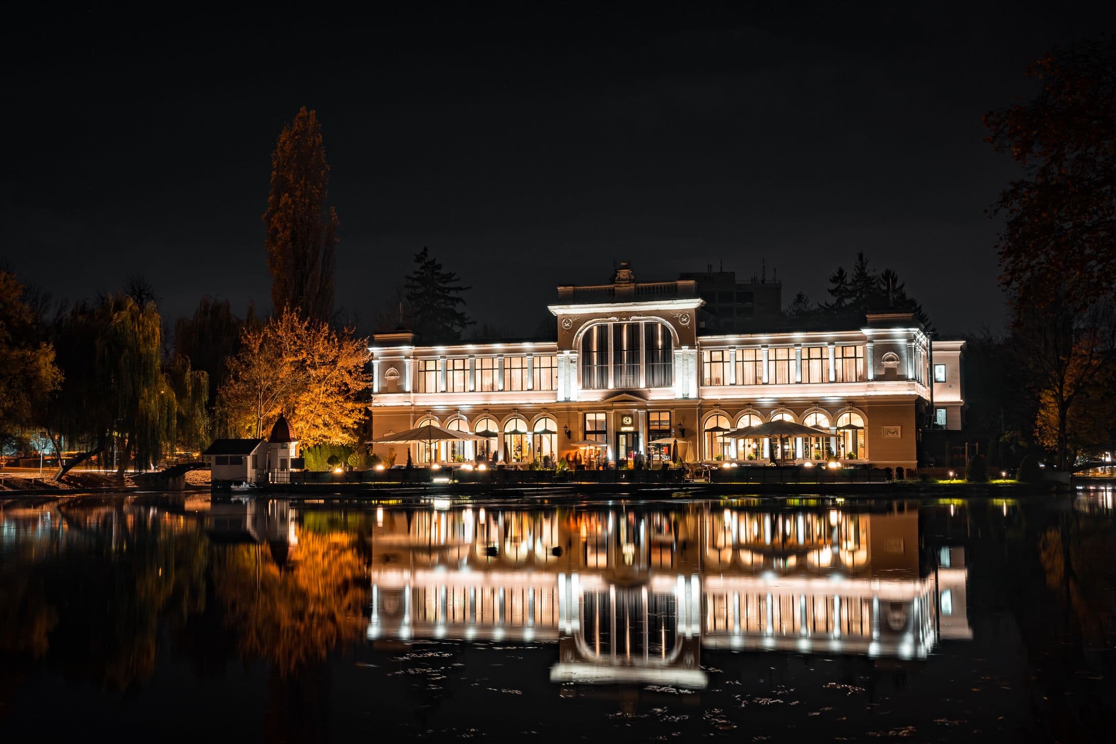 Lakeside home illuminated at night