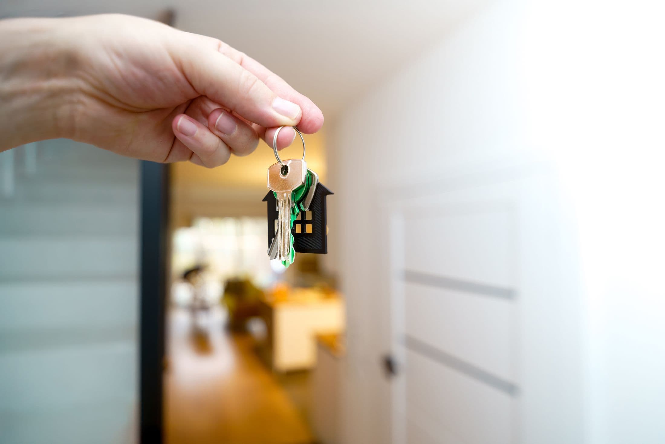 Hand holding new house keys